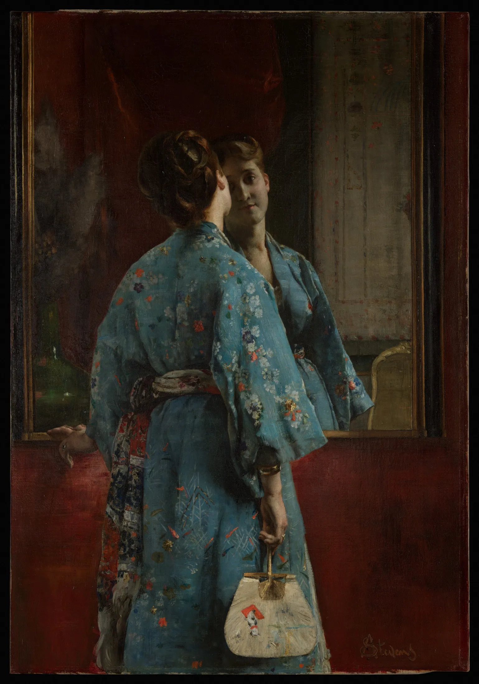 A fashionable European woman wearing a blue floral Japanese robe looks into a mirror while holding a round fan and a decorated handbag.