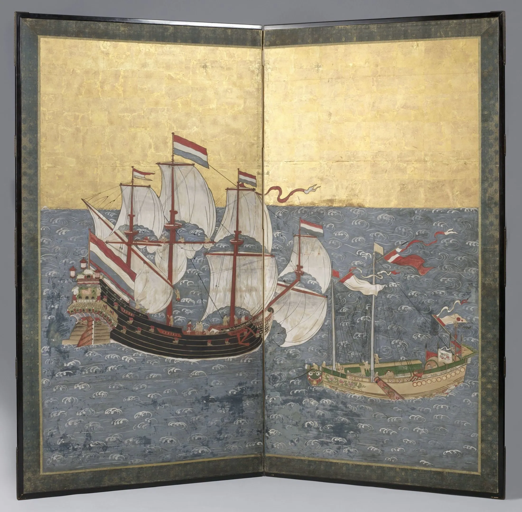 A Japanese screen shows a black-hulled Dutch ship flying multiple flags beside a decorated Chinese junk on a field of stylised blue waves.